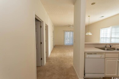 Corridor featuring sink and light carpet