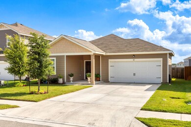 View of front of property with a garage and concrete driveway