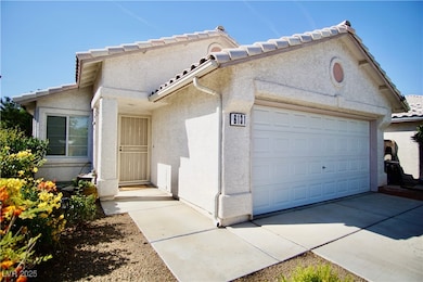 View of front of home with stucco siding, an attac