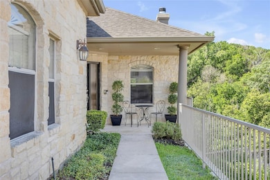 Doorway to property with stone siding, a shingled