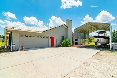 Side view of garage and over sized carport.
