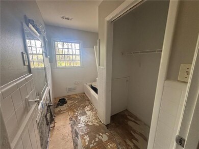 Bathroom featuring a garden tub and visible vents