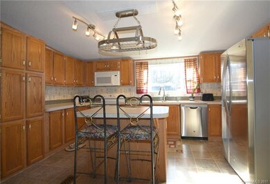Sunny kitchen with window looking out into the backyard.