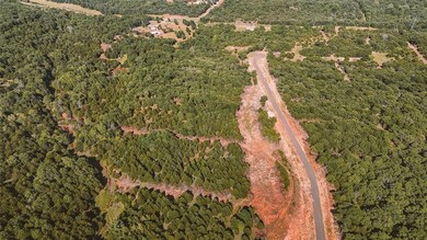 Aerial overview of property's location featuring a heavily wooded area
