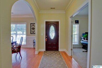 greets you with rich, honey colored hardwood flooring, crown molding and fresh paint just completed last year.