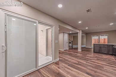 Bathroom with dark wood-style flooring and recessed lighting