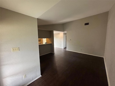 Unfurnished living room with baseboards, vaulted 