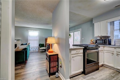 Entrance Foyer Opens into Kitchen, Dining Area, and Living Area