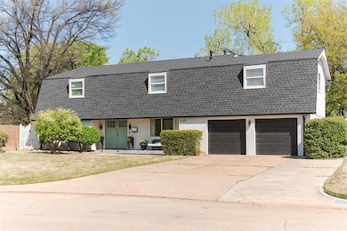 Colonial inspired home with fence, a front lawn, a