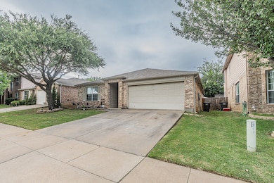 Ranch-style house featuring concrete driveway, brick siding, roof with shingles, and an attached garage
