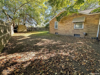 Fenced backyard with a shed