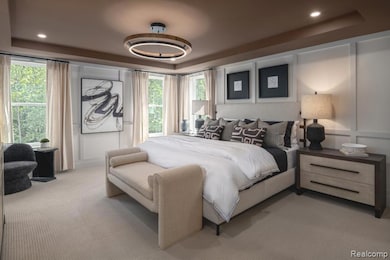 Bedroom featuring a tray ceiling, carpet, recessed lighting, and a decorative wall
