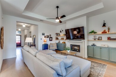 Living room featuring ceiling fan, a built-in elec