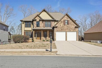 Craftsman-style home with a shingled roof, concret