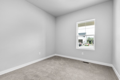 Unfurnished room featuring carpet and baseboards
