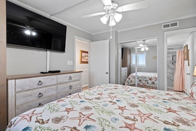 Bedroom featuring crown molding, a closet, ceiling