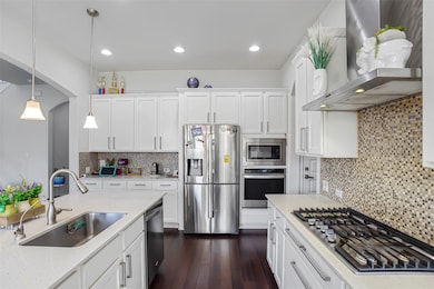 Kitchen with stainless steel appliances, a sink, 