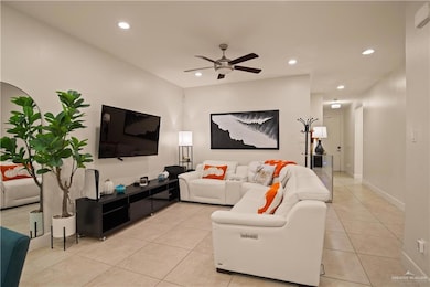 Living room featuring recessed lighting, light tile patterned floors, and ceiling fan