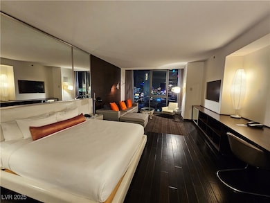 Bedroom featuring dark wood-style flooring and floor to ceiling windows