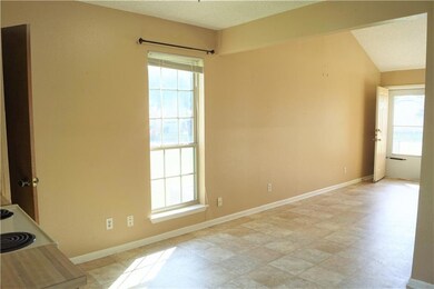Empty room with baseboards and a textured ceiling