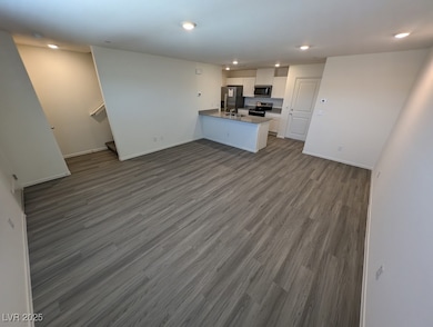Unfurnished living room with dark wood-style floor