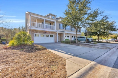 View of front facade with a garage and a balcony
