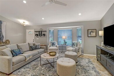 Living room featuring recessed lighting, light tile patterned floors, and a ceiling fan