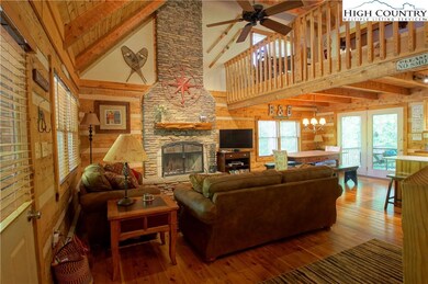 Airy great room with soaring stacked stone fireplace