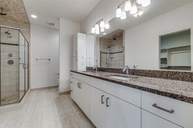 Bathroom with a shower with door, toilet, and dual