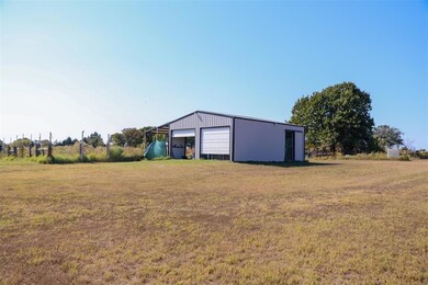 View of yard featuring an outbuilding and a garage