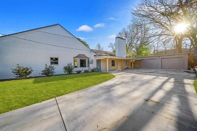 View of front facade with a garage, a chimney, and