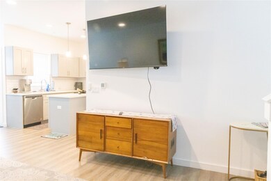Kitchen with light wood finished floors, backspla