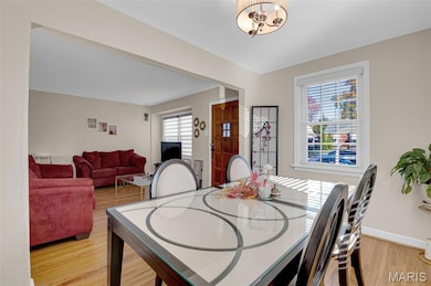 Dining area with light wood finished floors and baseboards