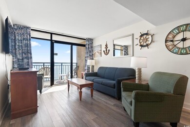 Living room featuring expansive windows and hardwo