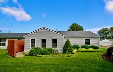 View of property exterior with a yard and garage