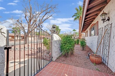 View of gate with fence and the other side of cour