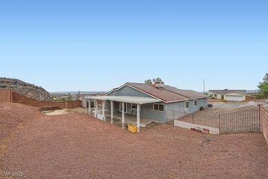 Rear view of house with a patio area, a tile roof,