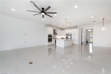 Unfurnished living room featuring light tile patte