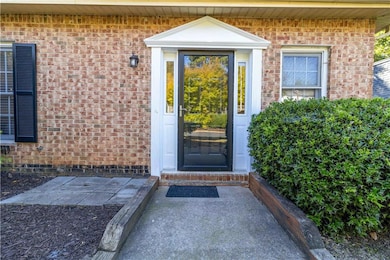 Entrance to property featuring brick siding