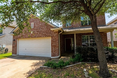 View of front of house with brick siding, drivewa