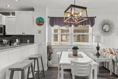 Dining room with an inviting chandelier, dark hard