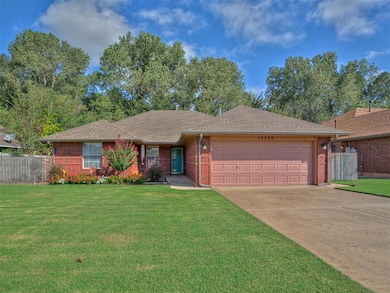 Ranch-style home with roof with shingles, brick siding, and concrete driveway