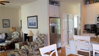 Kitchen with white cabinetry, hardwood / wood-styl