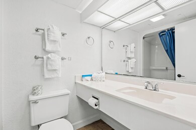 Bathroom featuring toilet, walk in shower, tile pa