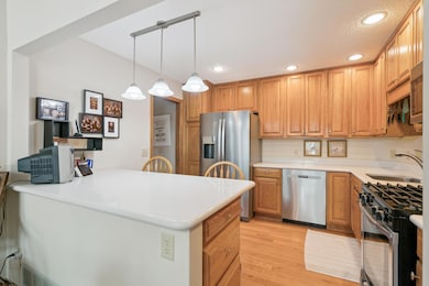 The kitchen has been updated with stainless steel appliances, hardwood floors & nice countertops & backsplash!