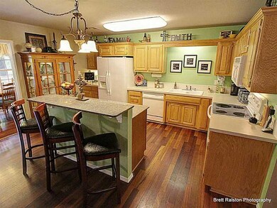 Kitchen. Hardwood floors continue into kitchen where there is lots of counter space and cabinets