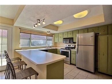 Nice kitchen has handy snack bar and pantry.