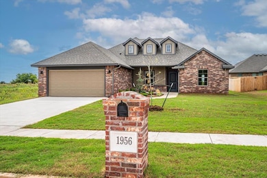 View of front of house featuring a porch, brick siding, a shingled roof, a garage, and concrete driveway