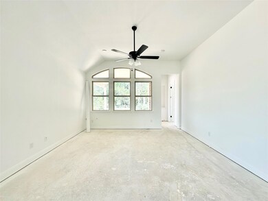 Empty room featuring a ceiling fan, concrete floo