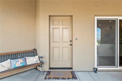 Entrance to property with stucco siding